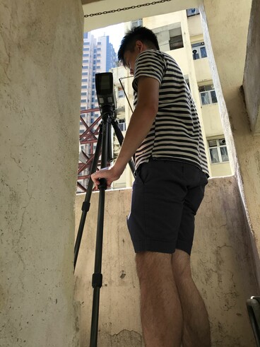 Engineer setting up the 3D-laser scanner to capture details of the external walls of the subject buildings